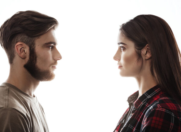 Side view. Man and woman facing each other, eyes open.