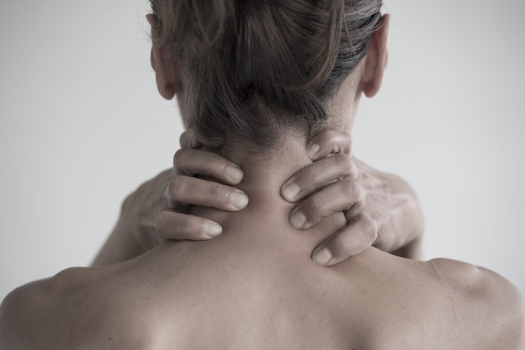 Closeup shot of a female having a neck pain