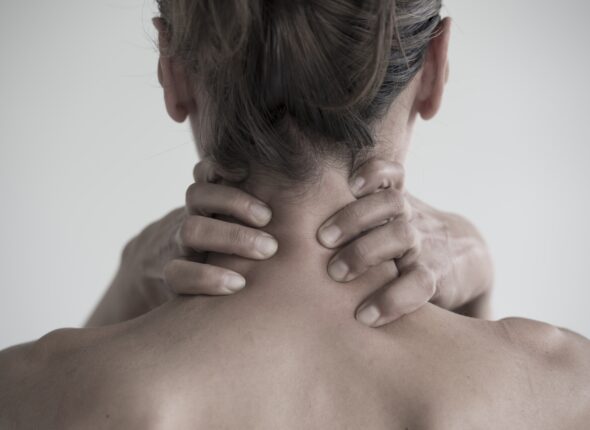 Closeup shot of a female having a neck pain