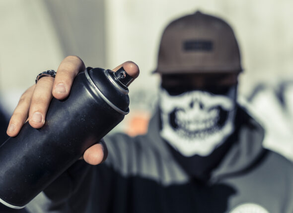 close-up-man-s-hand-holding-black-aerosol-can