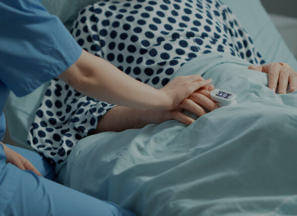 close-up-nurse-comforting-ill-patient-hospital-ward