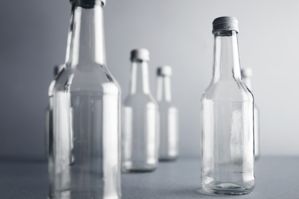 Empty glass cocoktail bottle with white cap mockup set