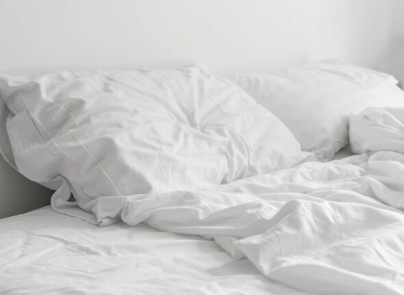 rumpled bed with white messy pillow decoration in bedroom